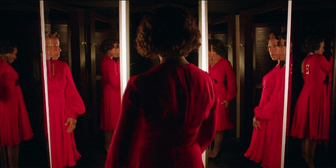 Image from In Fabric of women in red dress looking into a mirror
