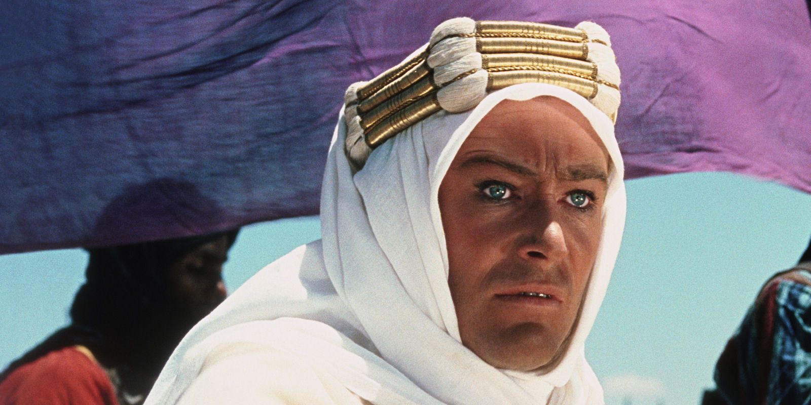 Lawrence looks out at something offscreen in Lawrence of Arabia.