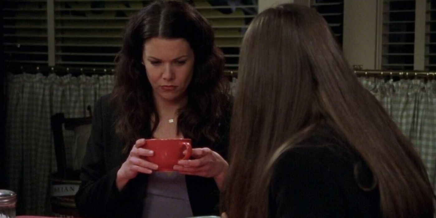 Lorelai holding a cup of coffee and talking to Rory on Gilmore Girls