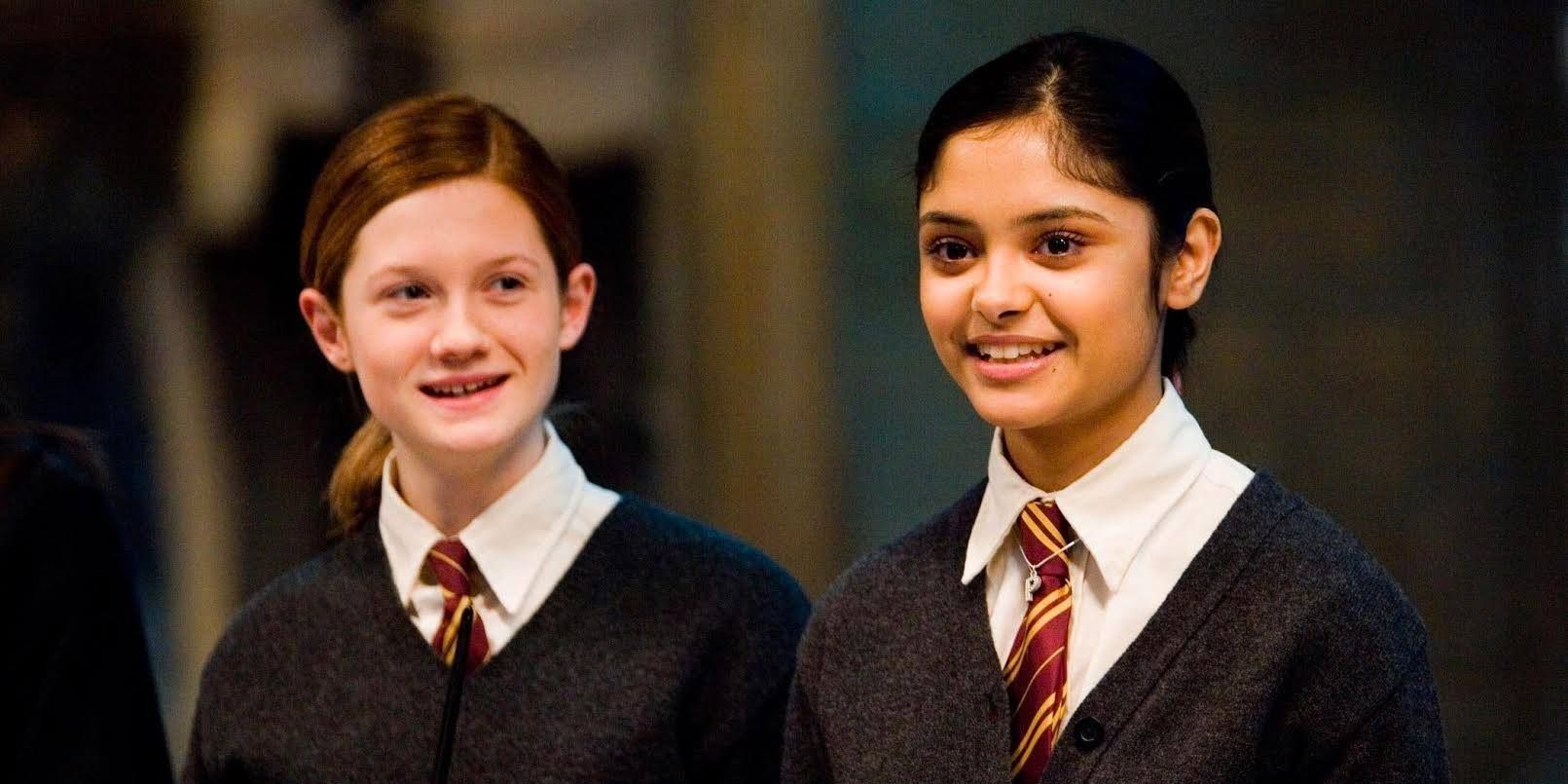 Padma Patil and Ginny Weasley in Harry Potter standing side by side and smiling.