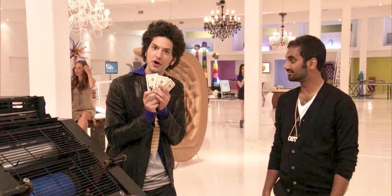 Jean holding cash standing alongside Tom at Entertainment 720