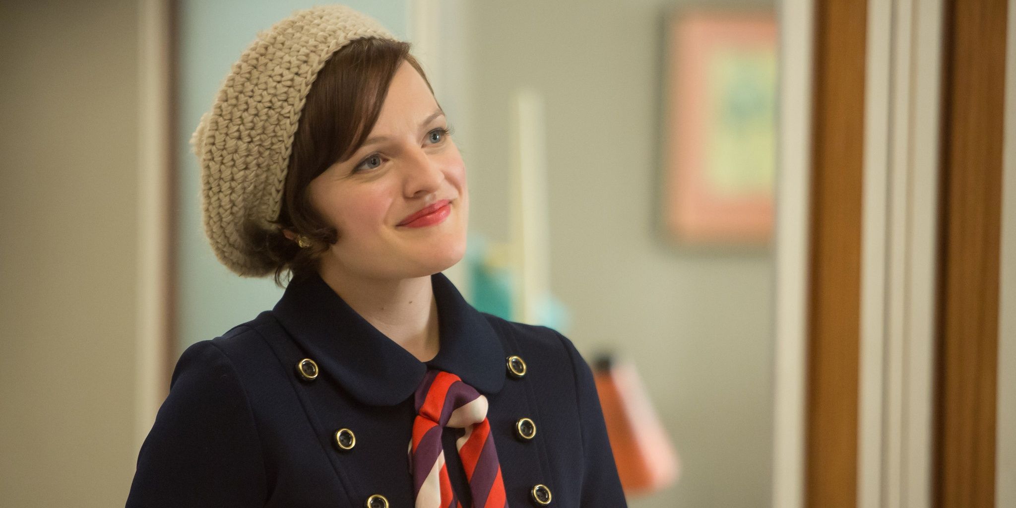 Peggy wearing a blue jacket and wool cap on Mad Men