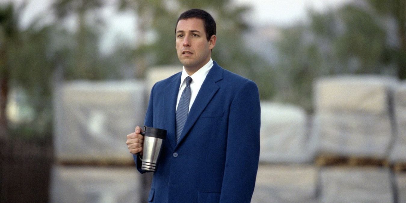 Barry holds a cup and looks sad in Punch-Drunk Love