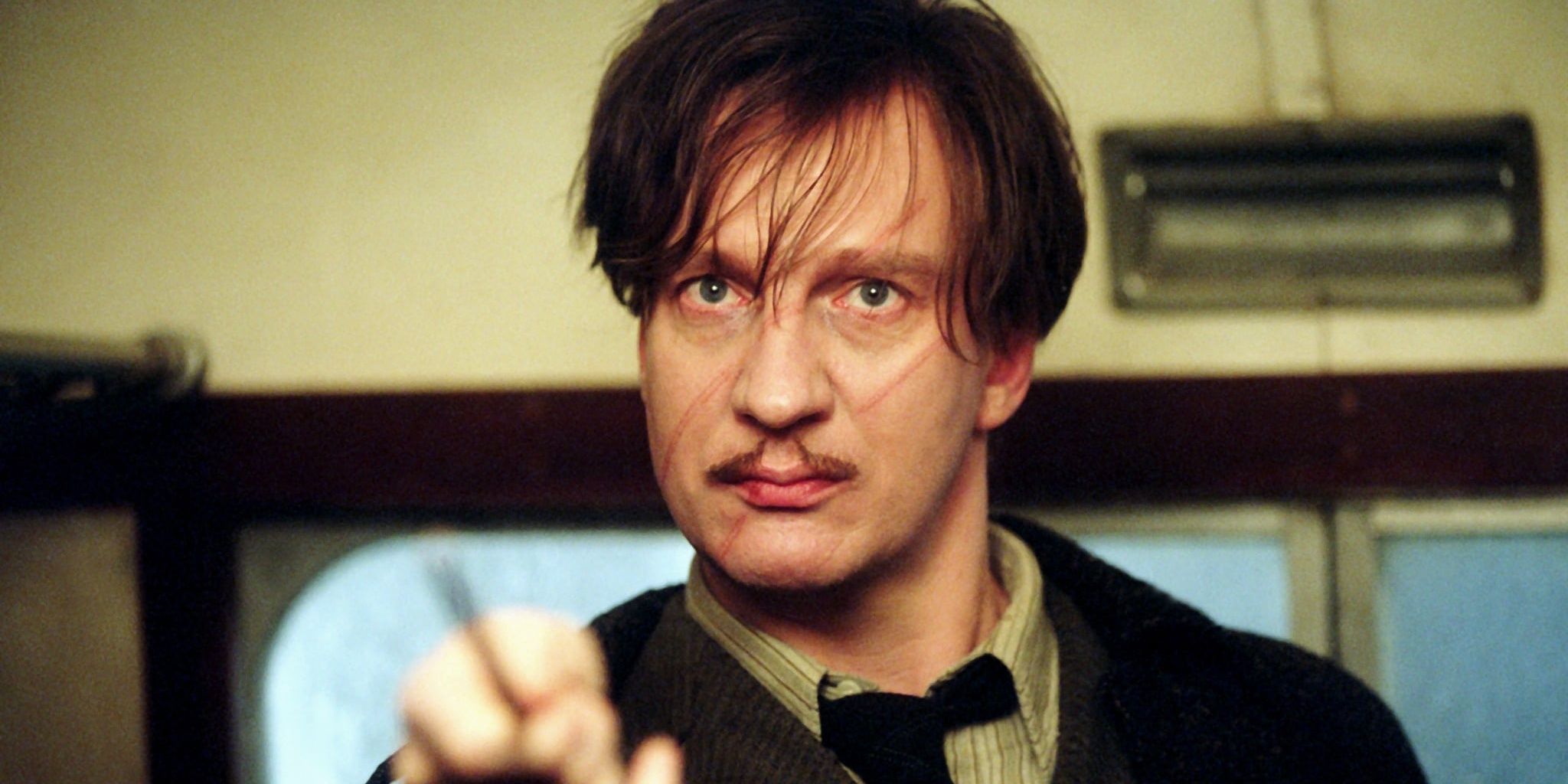 Remus Lupin points his wand at someone in Harry Potter and the Prisoner of Azkaban