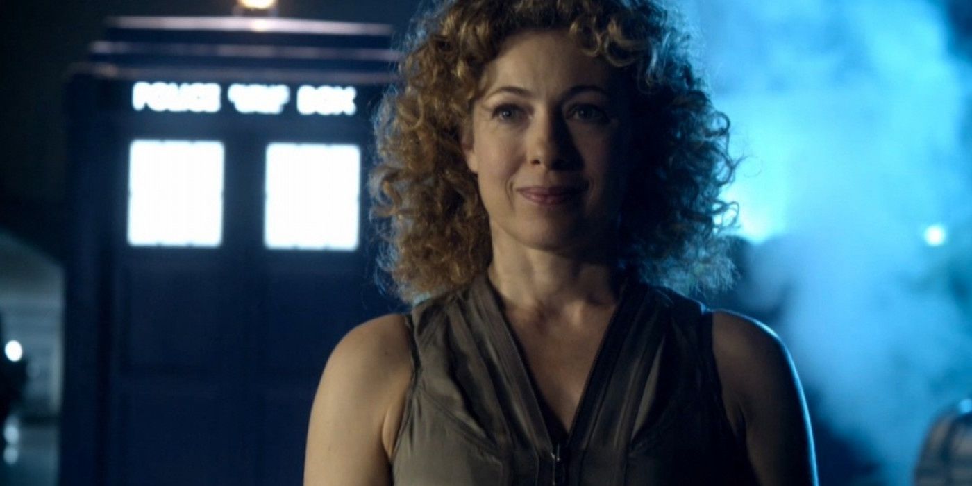 An image of River Song smiling at the camera with the TARDIS glowing in the background.