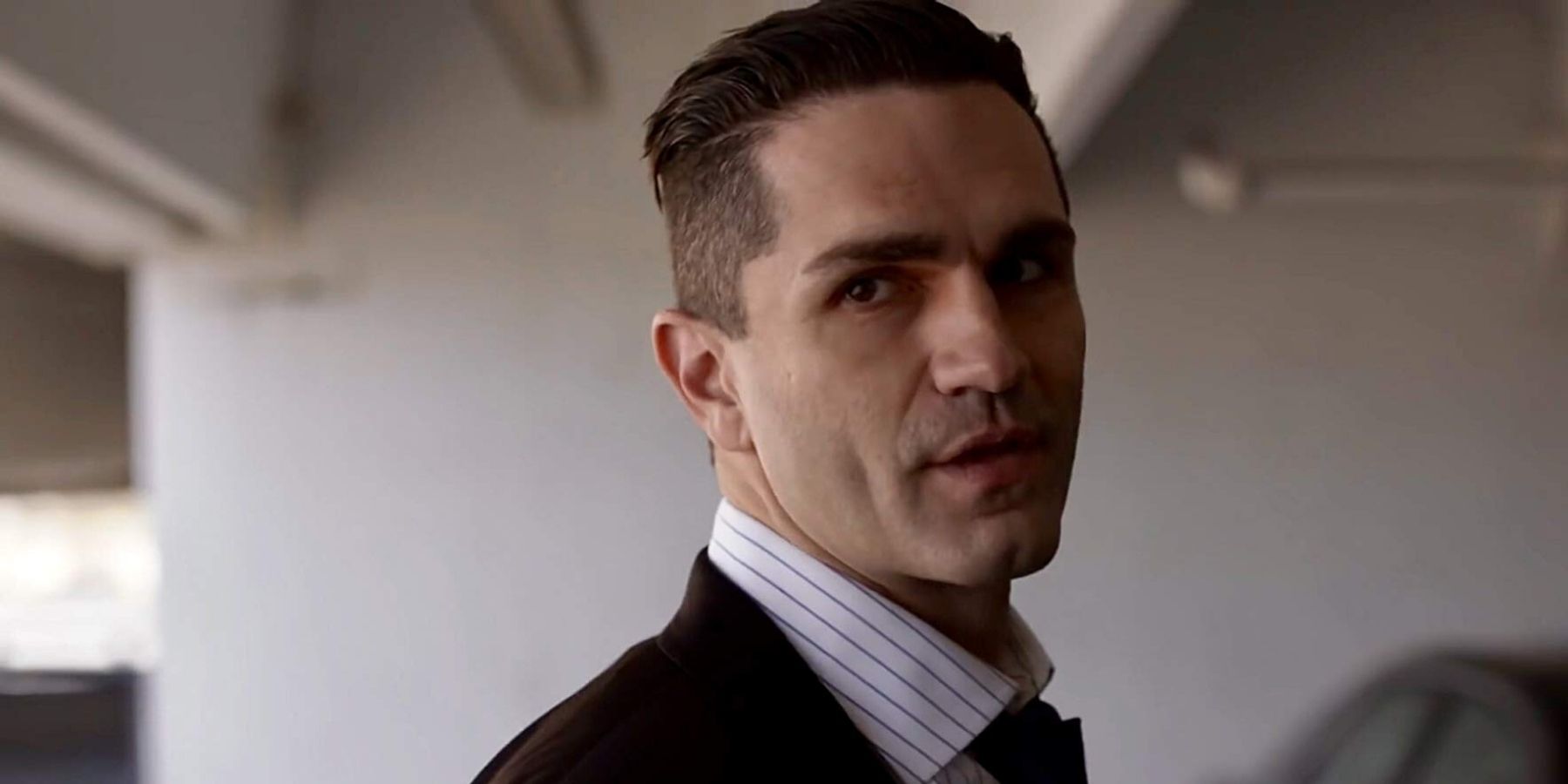 Sam Witwer in a suit in a parking garage