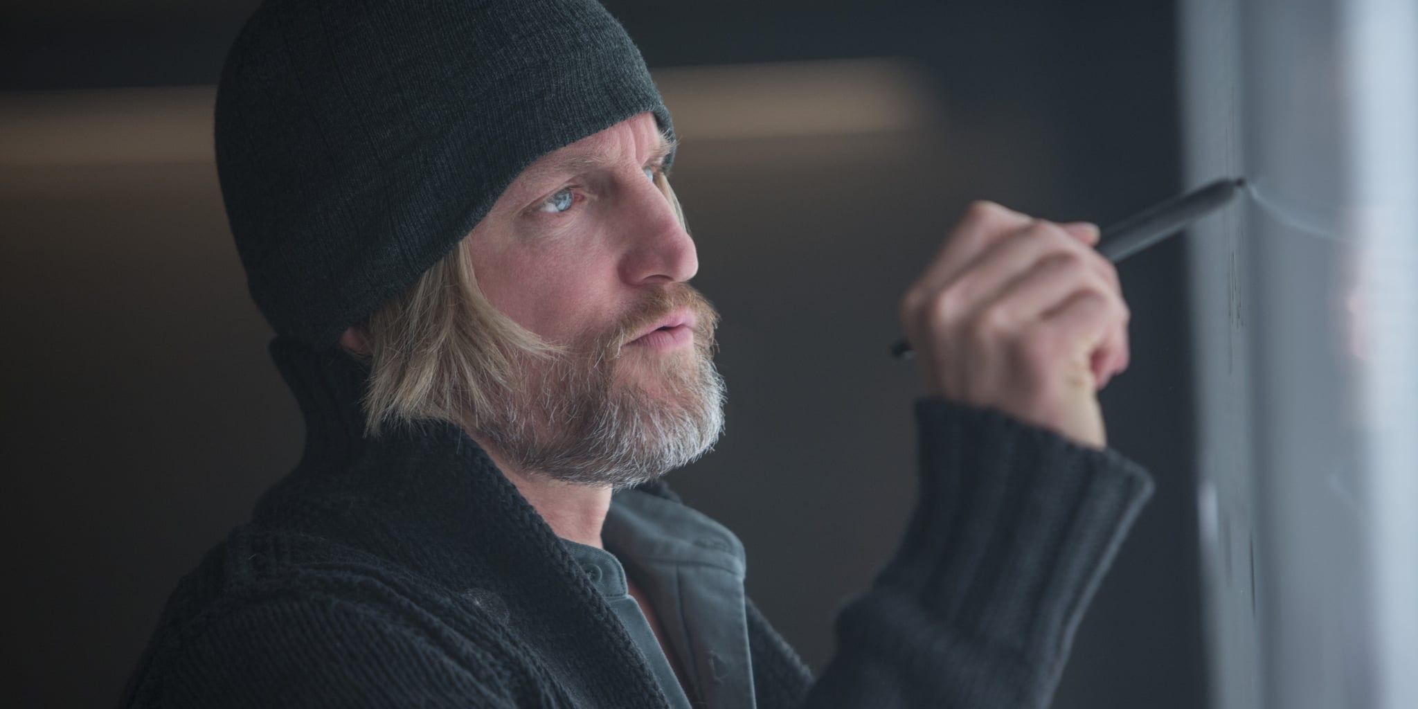 Haymitch writes on a board in Hunger Games