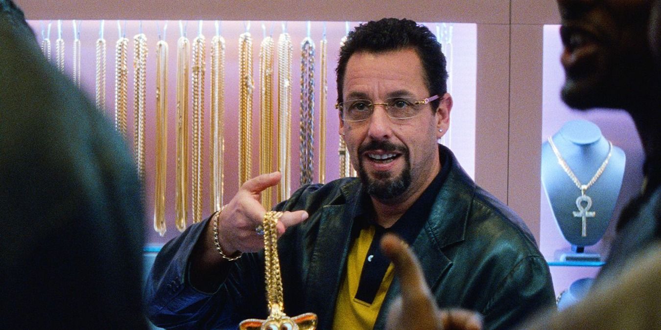 Adam Sandler holding up jewellery in his shop in Uncut Gems