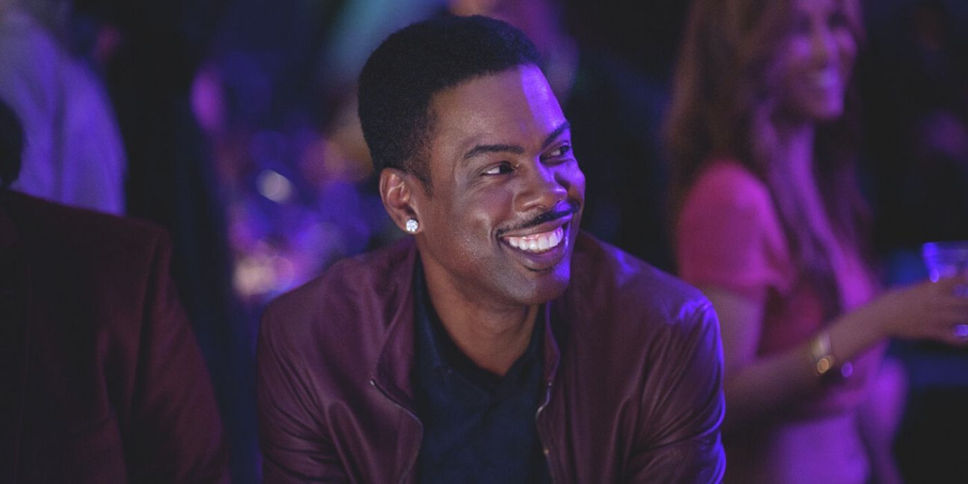 Chris Rock grinning in a club