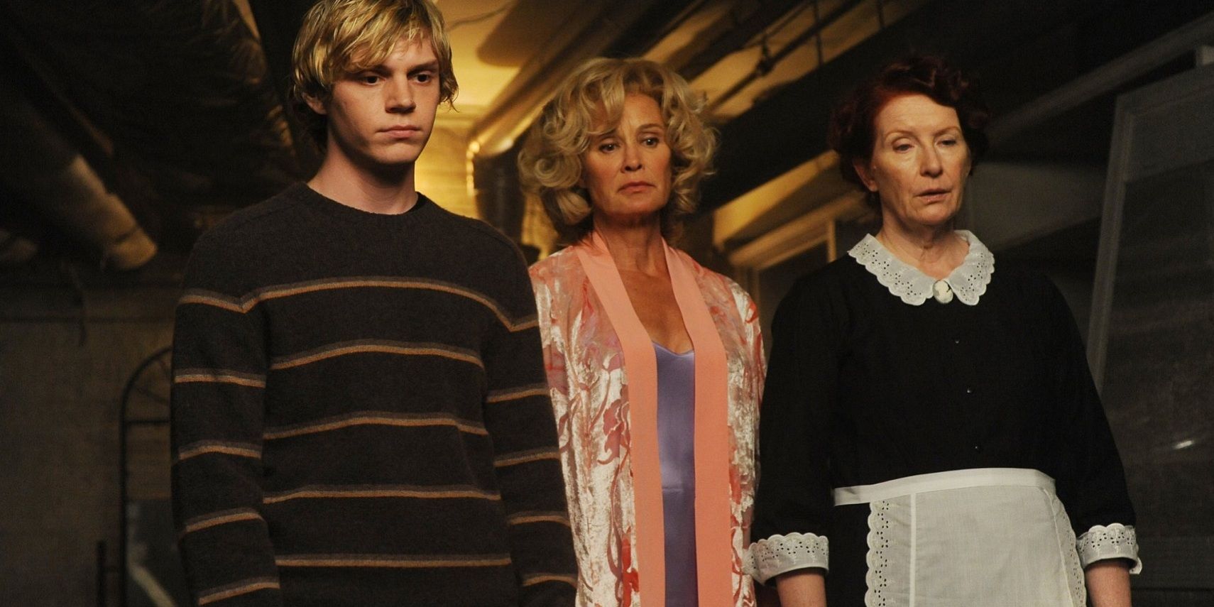 Moira standing with Tate and Constance in American Horror Story Murder House