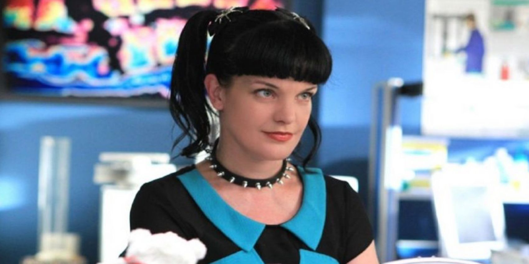 Abby Sciuto smiling and looking to the distance In NCIS