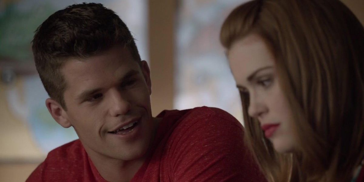 Aiden talking to Lydia and smiling while she looks serious on Teen Wolf.