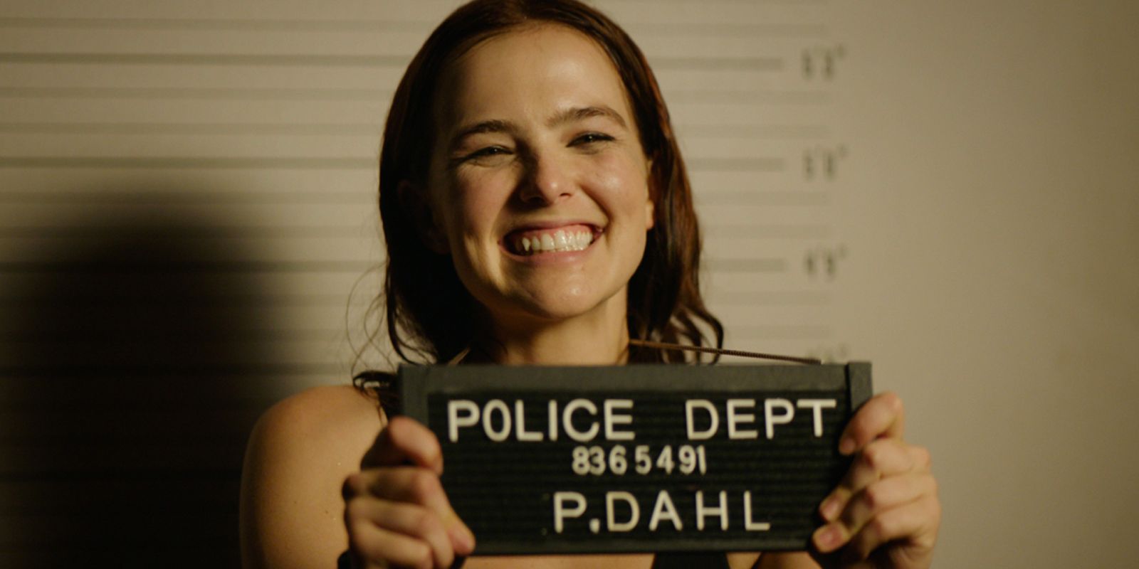 Zoey Deutch poses for a mugshot in Buffaloed