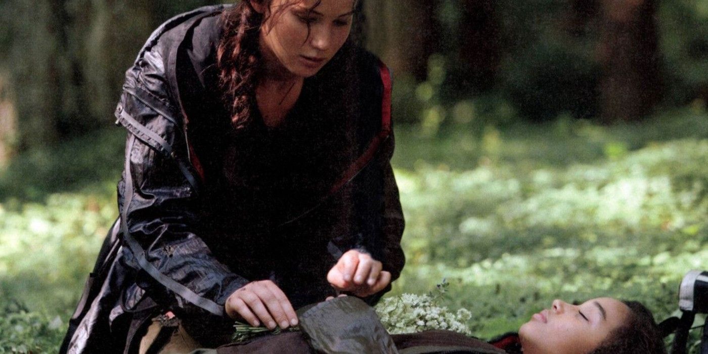 Katniss placing flowers around Rue in The Hunger Games.