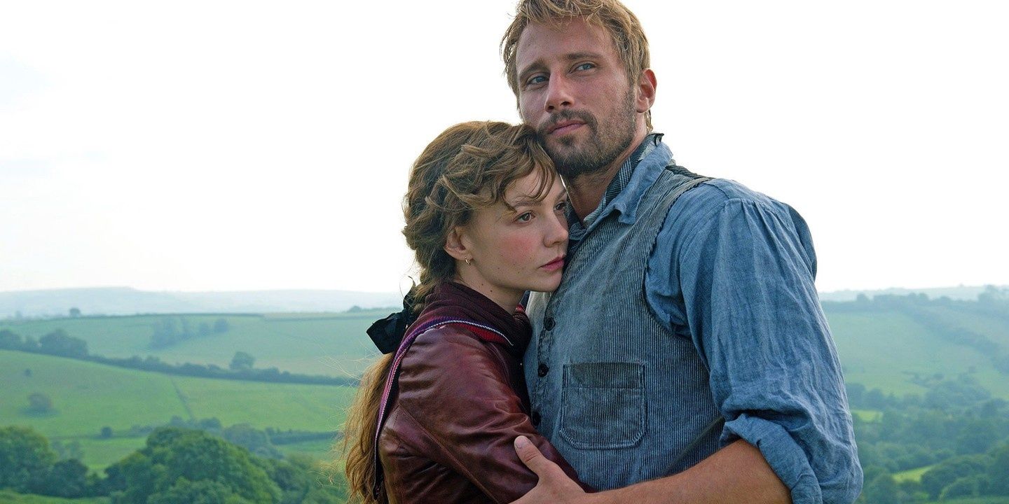 Carey Mulligan and Matthias Schoenaerts embrace on a hilltop in Far From The Madding Crowd 