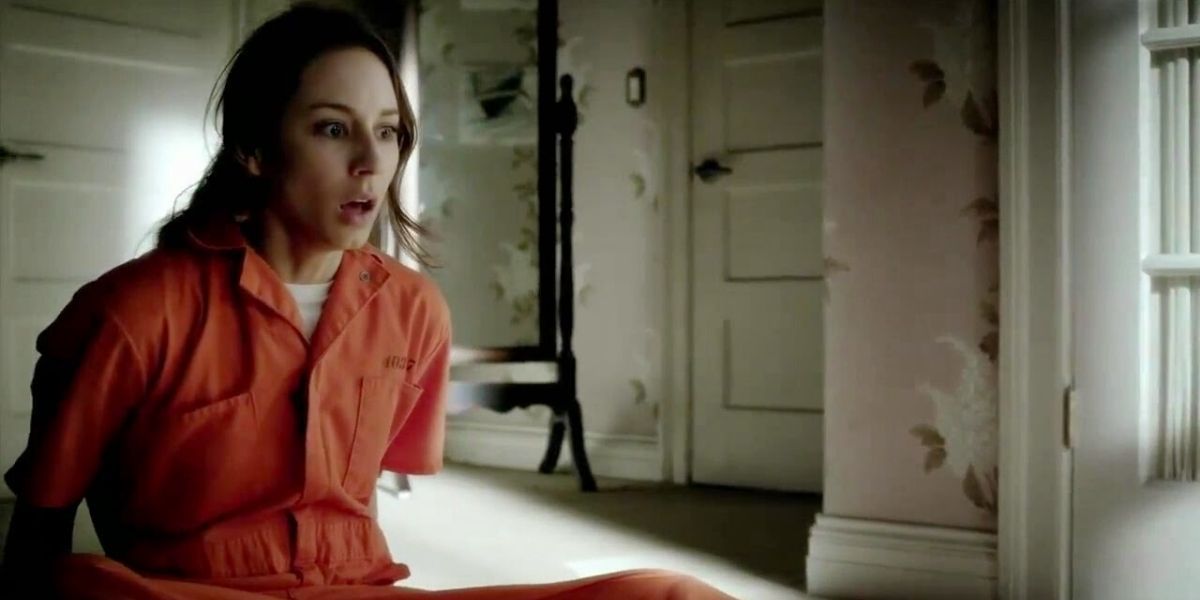 Spencer in prisoner's uniform, looking terrified in dollhouse