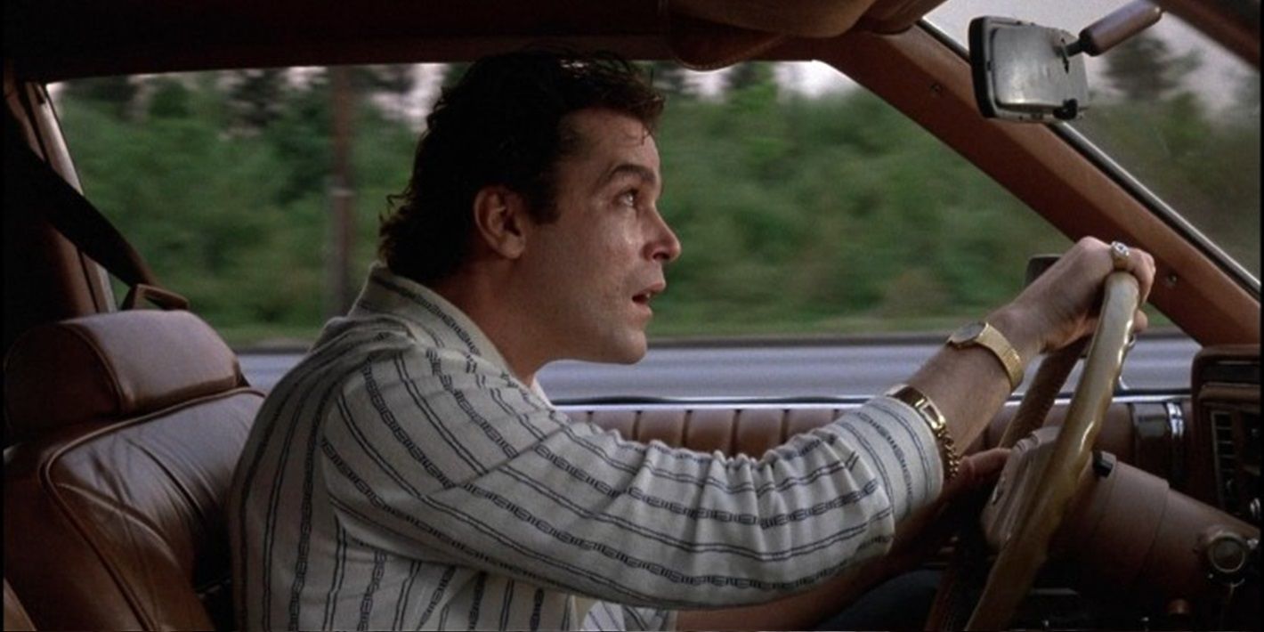 Henry drives a car and looks up at the sky in Goodfellas
