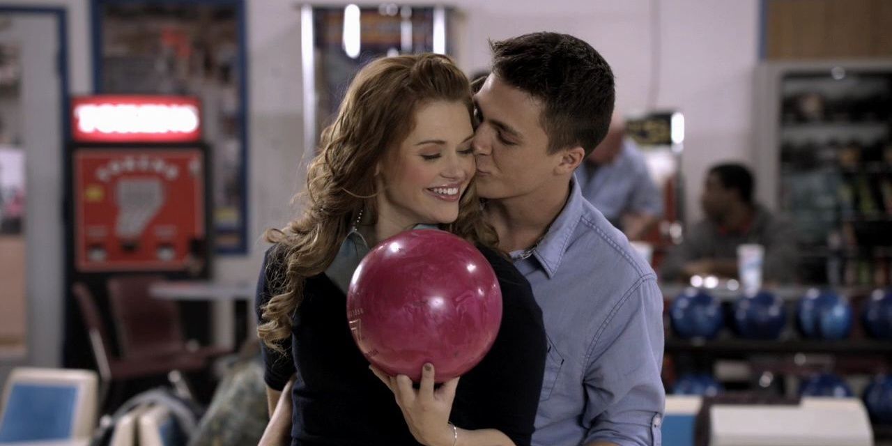 Jackson kisses Lydia's cheek as she holds a bowling ball in Teen Wolf