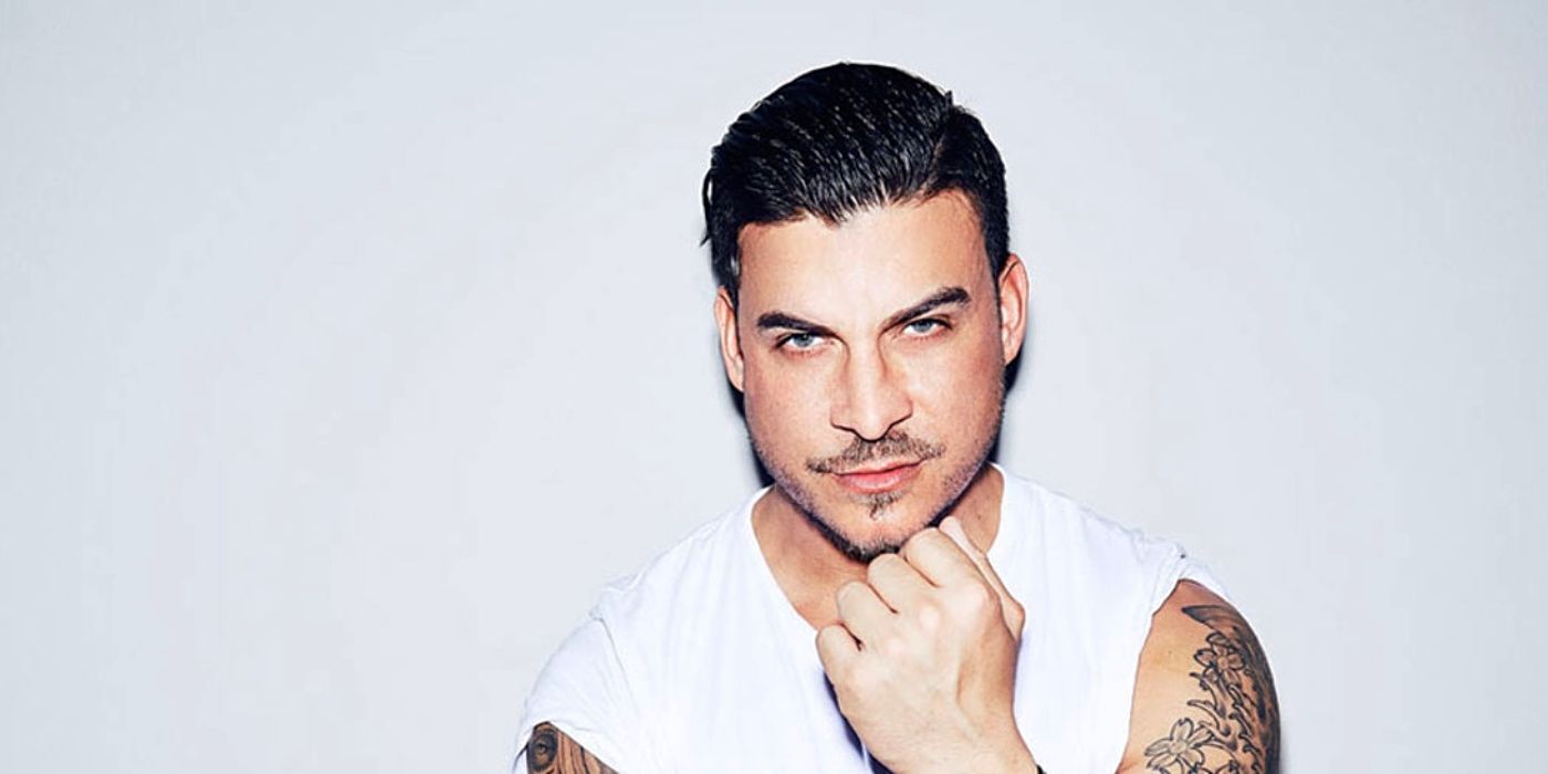 Jax Taylor from Vanderpump Rules posing in white shirt against white background
