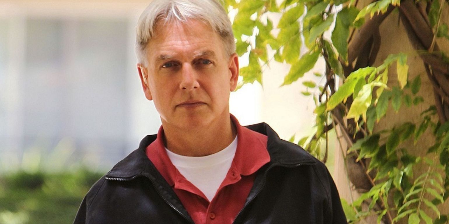 Leroy Jethro Gibbs wearing a red shirt and a black jacket while looking seriously at someone in NCIS