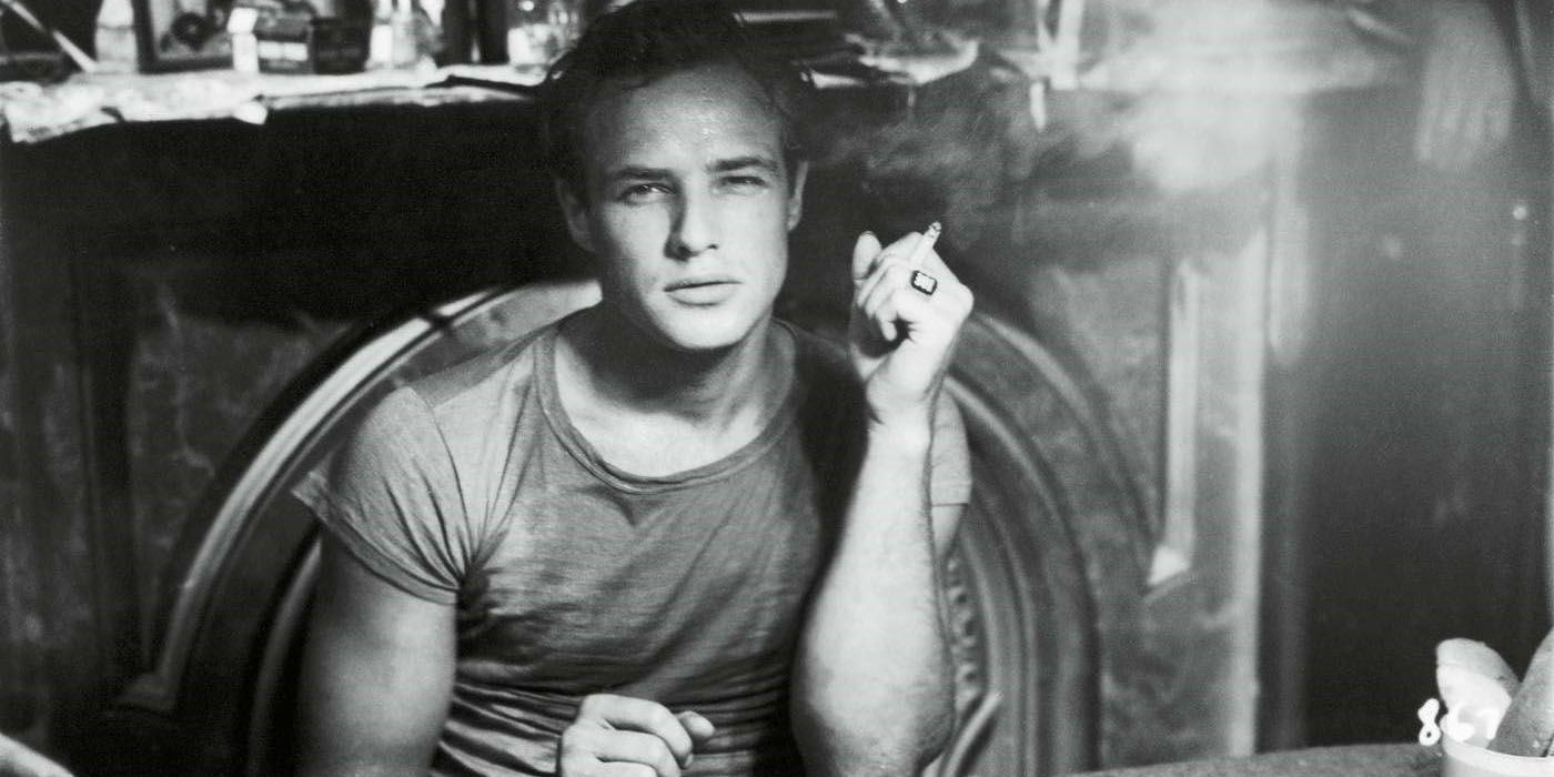 Marlon Brando sitting at a table.