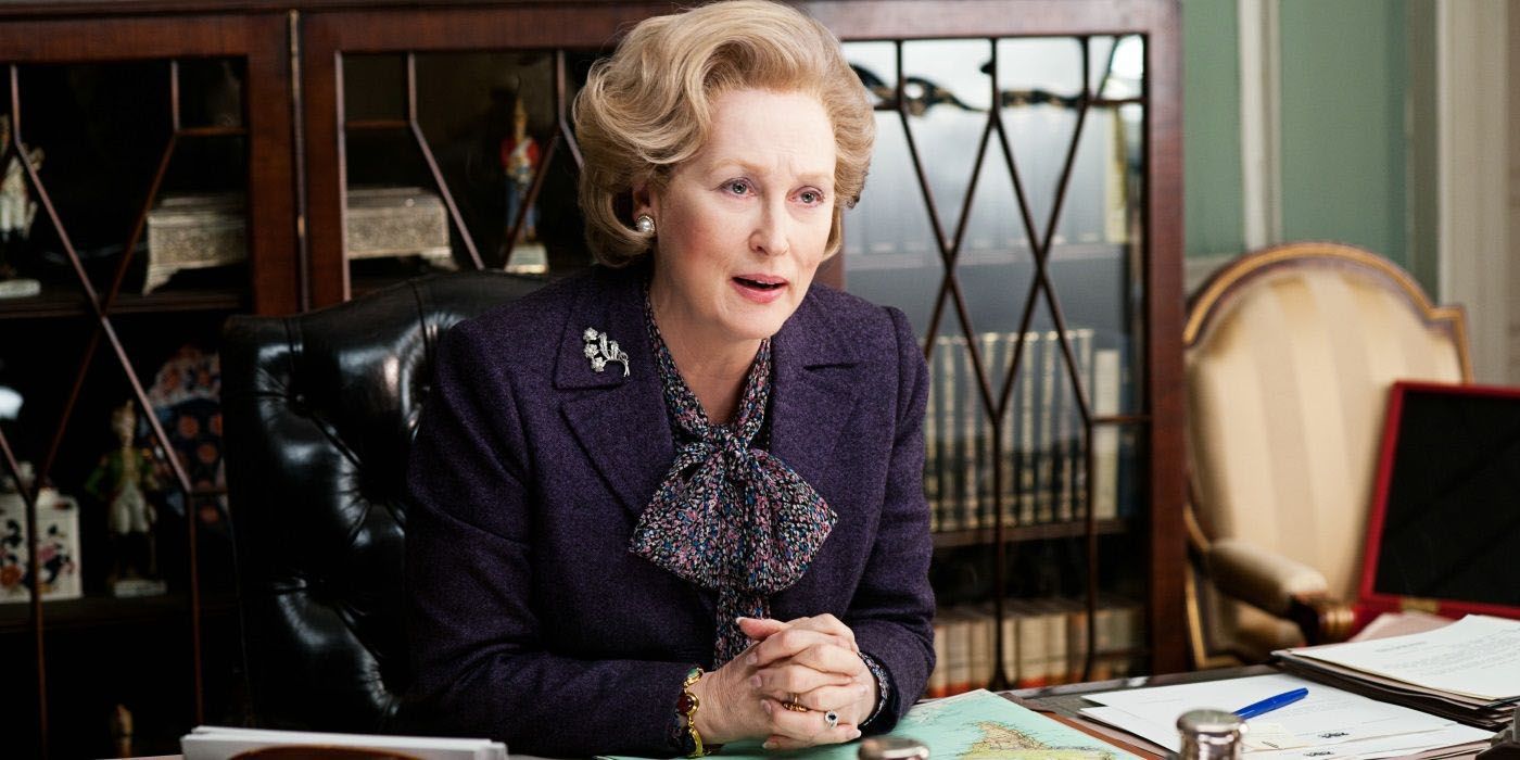 Meryl Streep sitting at a desk as Margaret Thatcher