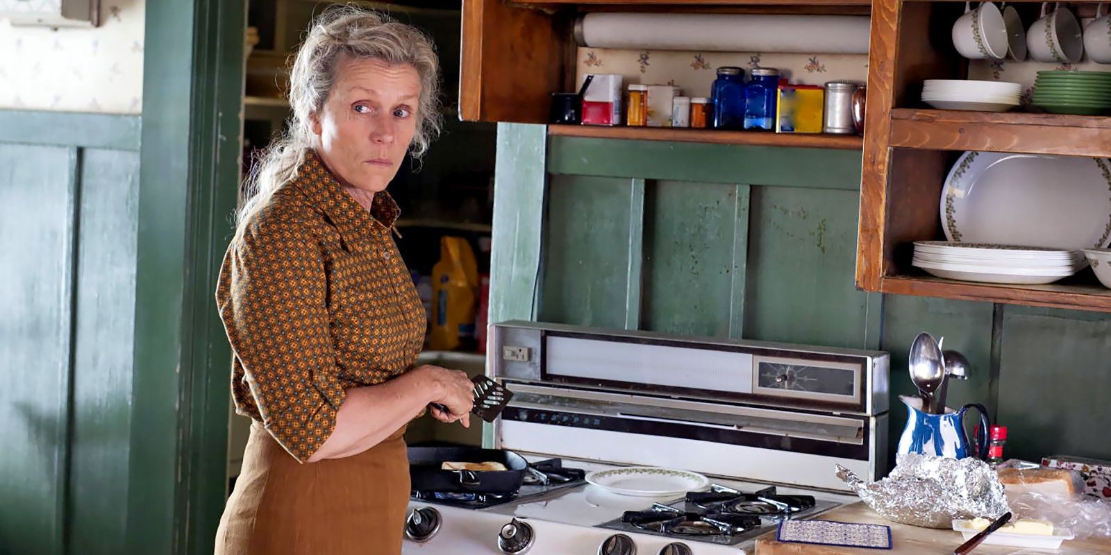Frances McDormand stands at an oven in Olive Kitteridge