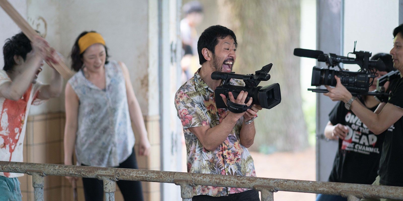 The director about to get hit in the head by an actor in One Cut of the Dead