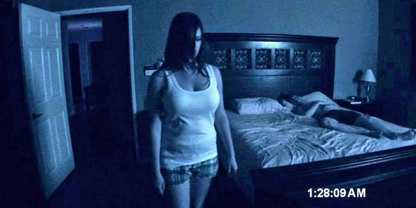 A woman standing in her bedroom in Paranormal Activity