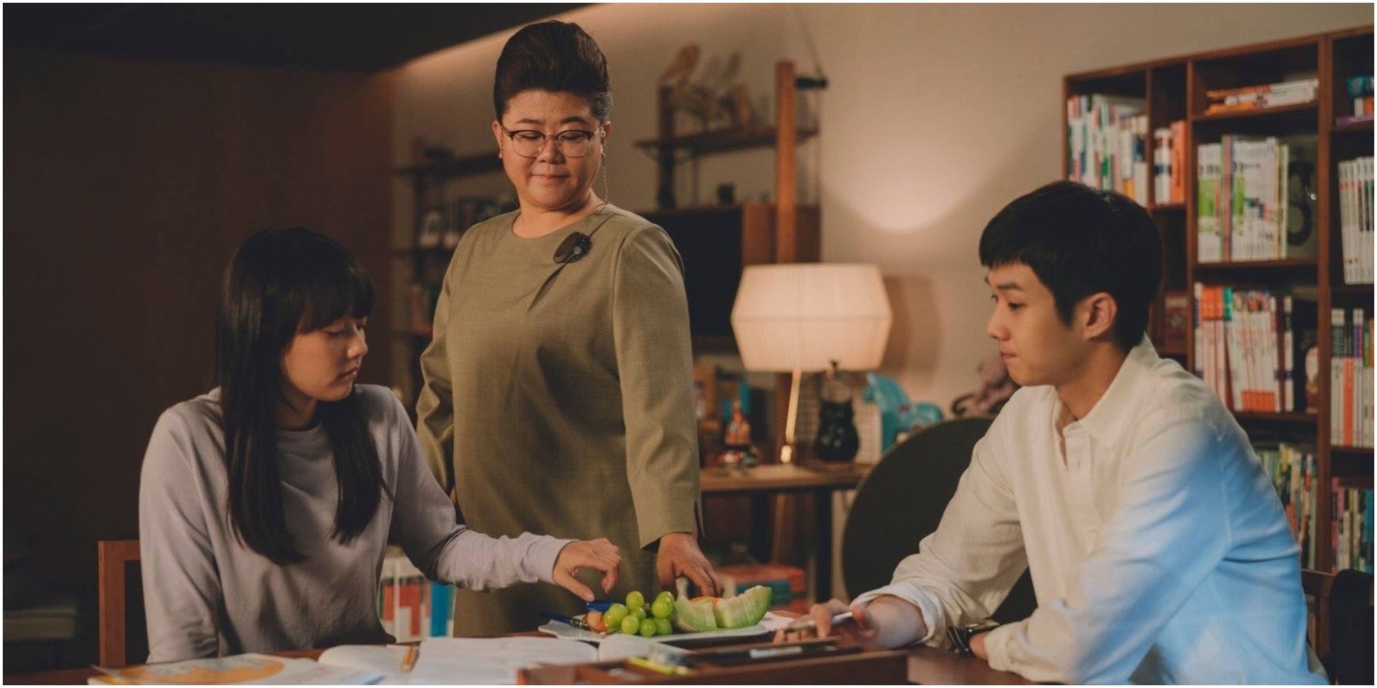 Ki-woo and Da-hye sitting at a table in Parasite