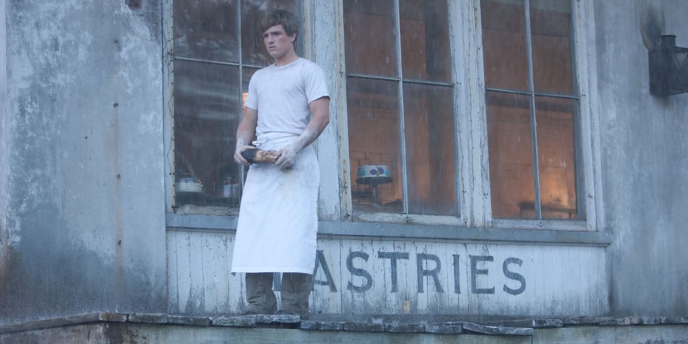 Peeta holding bread in The Hunger Games