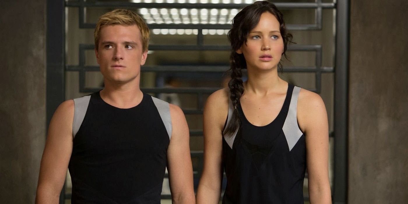 Peeta and Katniss stand next to one another in Catching Fire.