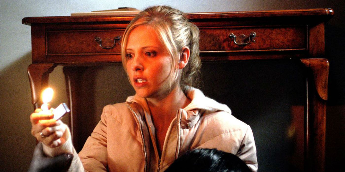 Sarah Michelle Gellar holding a lighter up in the house in The Grudge 2004