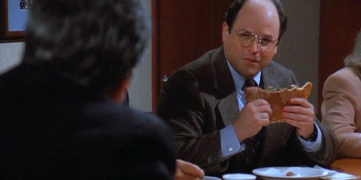 George holding a calzone on Seinfeld
