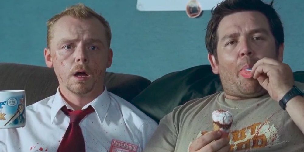 Shaun and Ed watch the news after kiling zombies in Shaun of the Dead