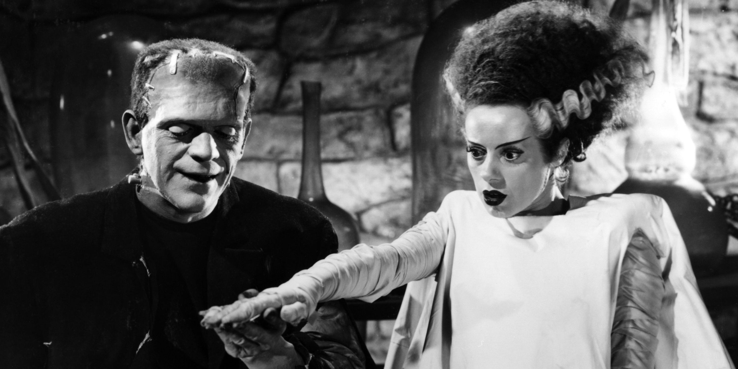 The Bride of Frankenstein learns to move as Frankenstein grins