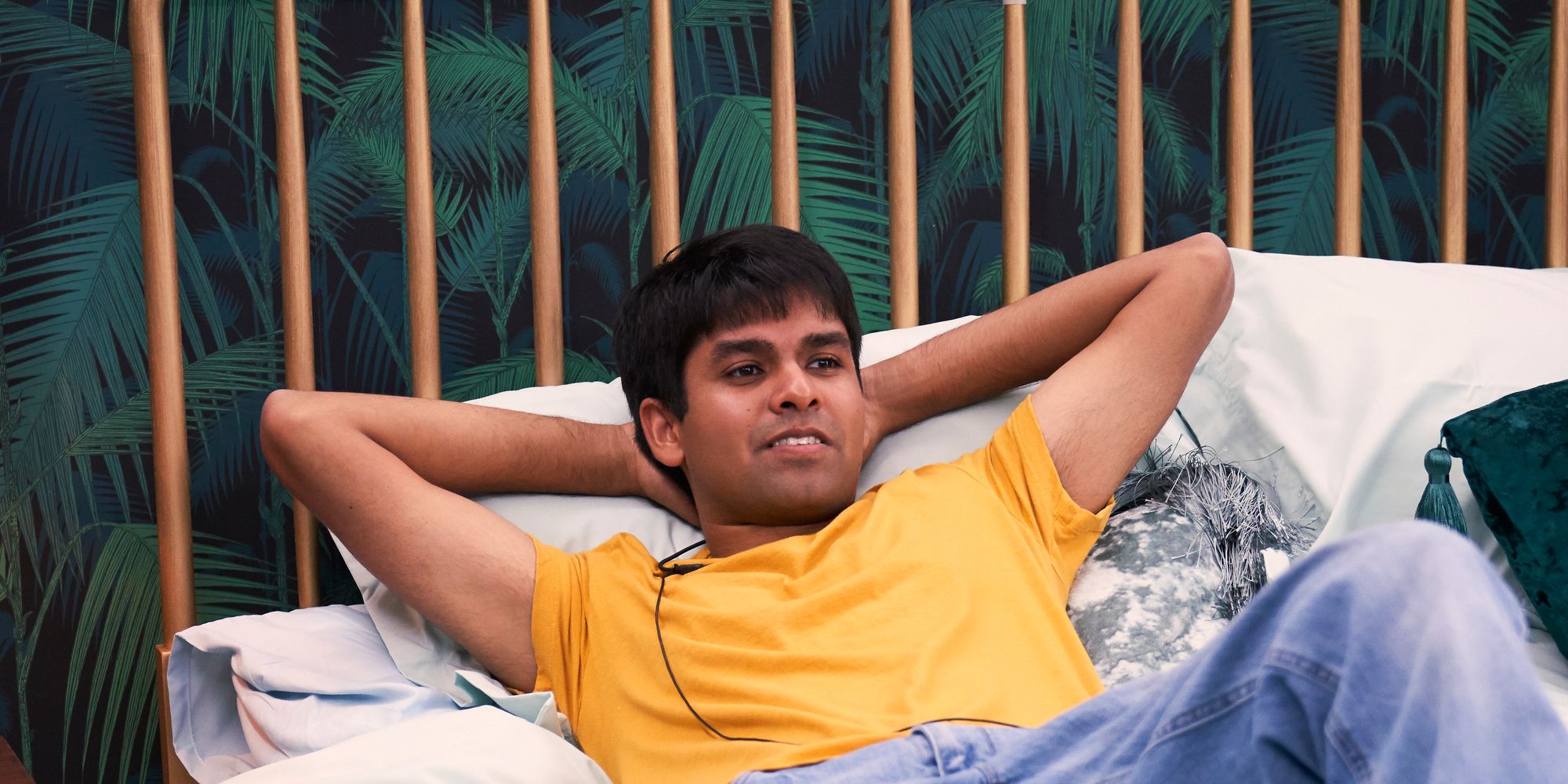 The Circle Shubham Goel wearing yellow shirt lying back