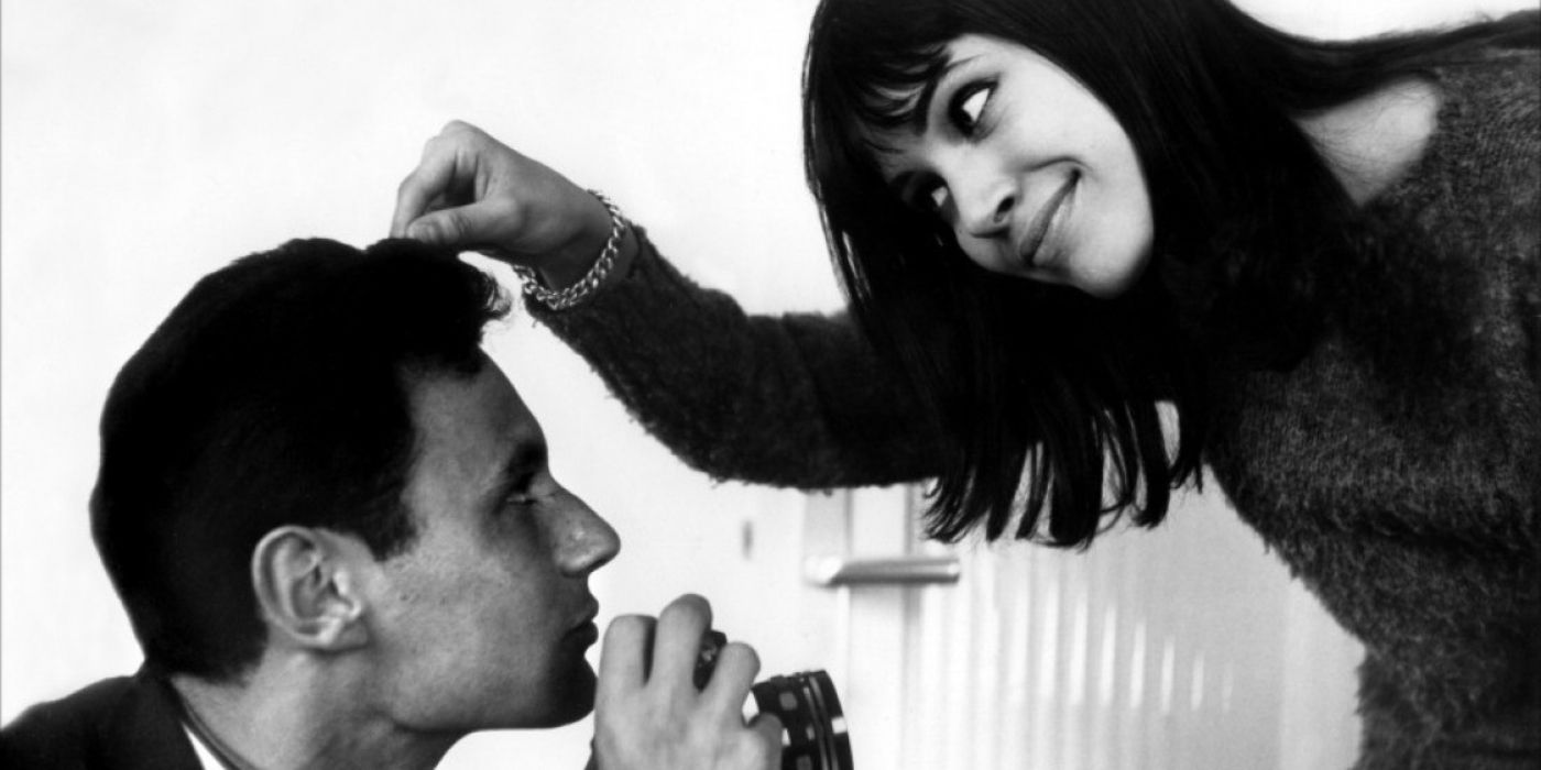 A woman smiles as she pokes a man's head in The Little Soldier / Le Petit Soldat 1963.