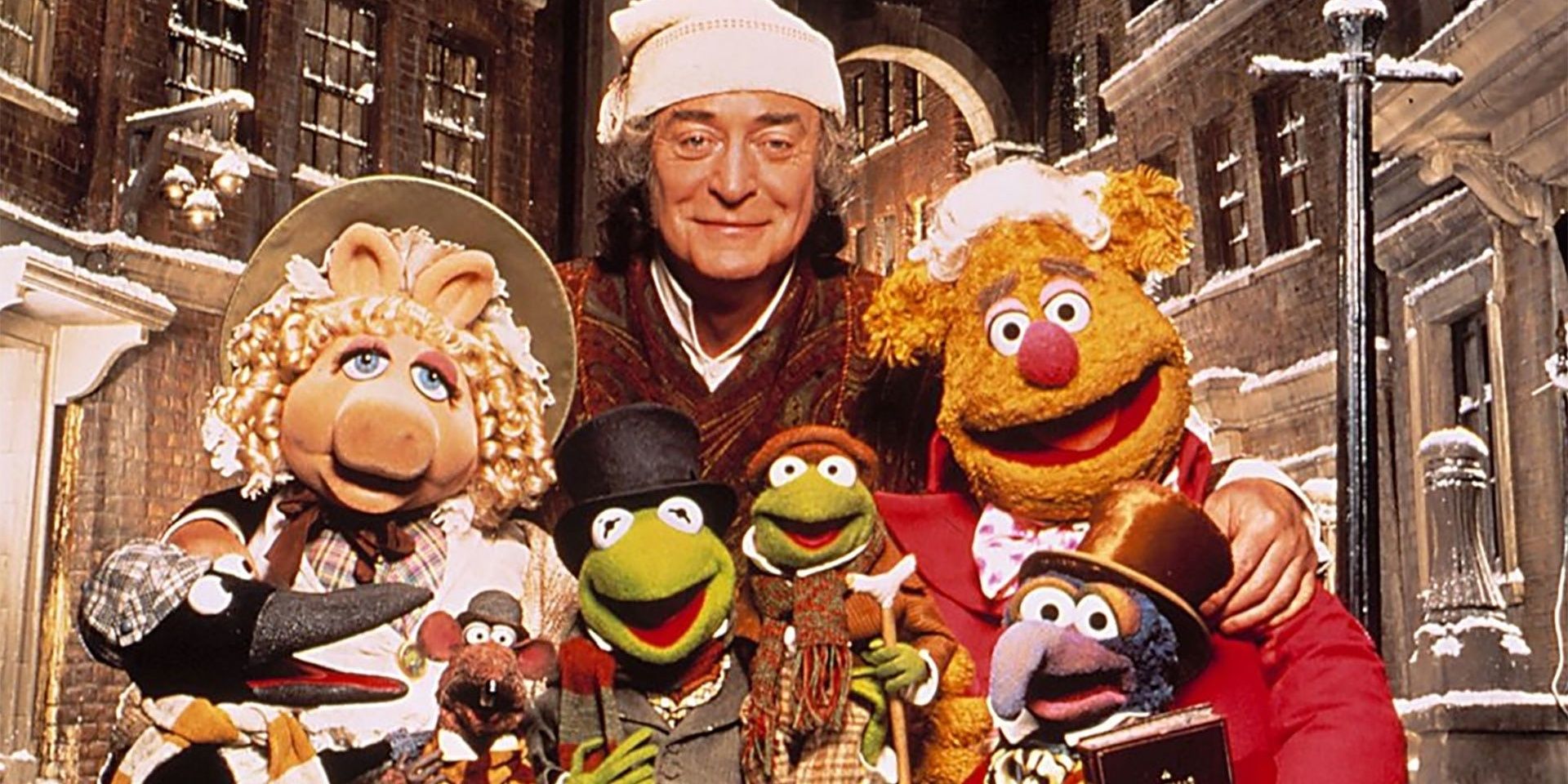 Michael Caine poses with the Muppets in The Muppet Christmas Carol