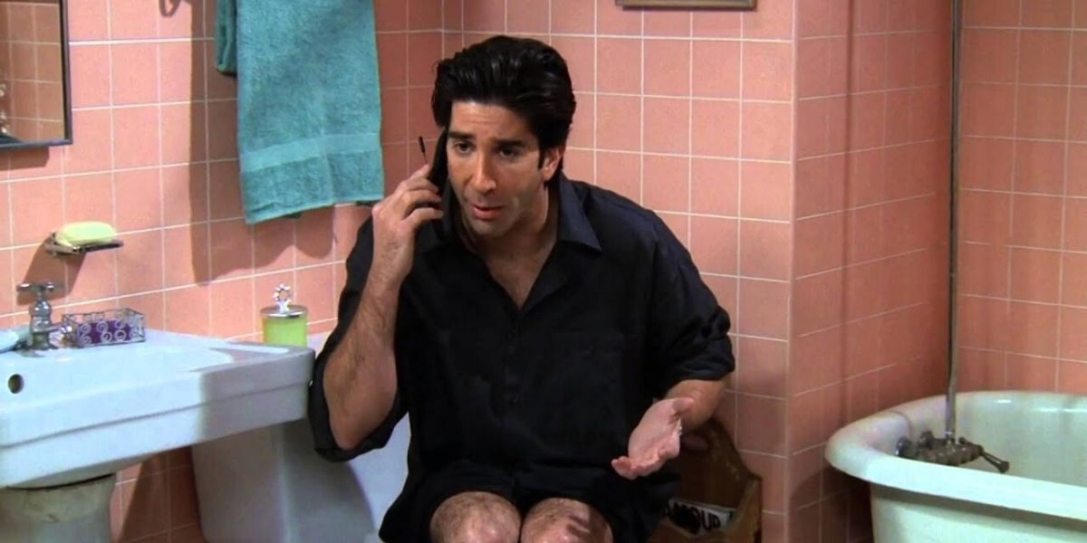 Ross with his leather pants down calls Joey from the bathroom in Friends