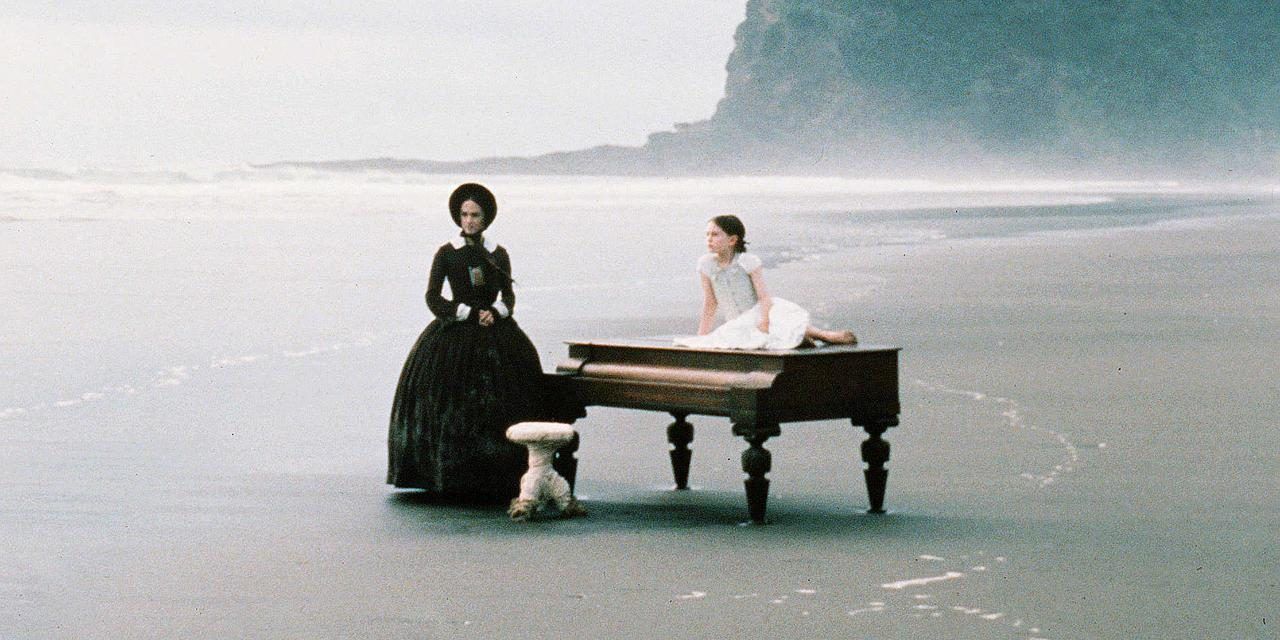 Ada and Flora with a piano on the beach in The Piano