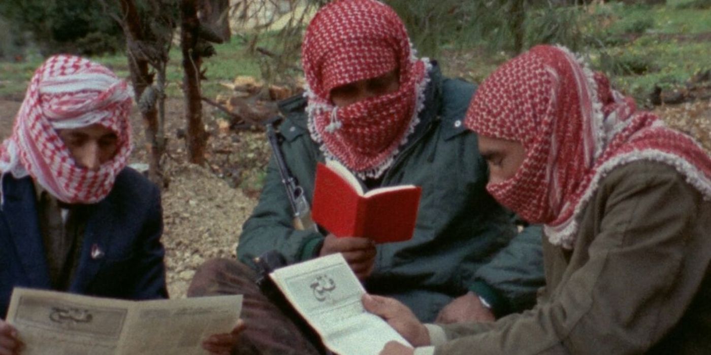 Three men reading in Here And Elsewhere / Ici Et Ailleurs (1976).