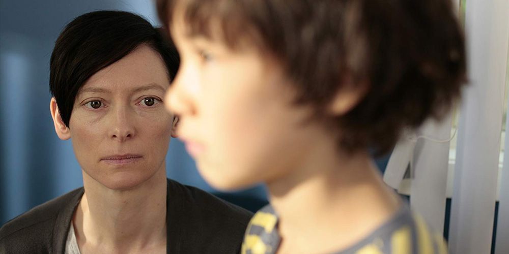 Tilda Swinton staring at a young Kevin in We Need to Talk About Kevin