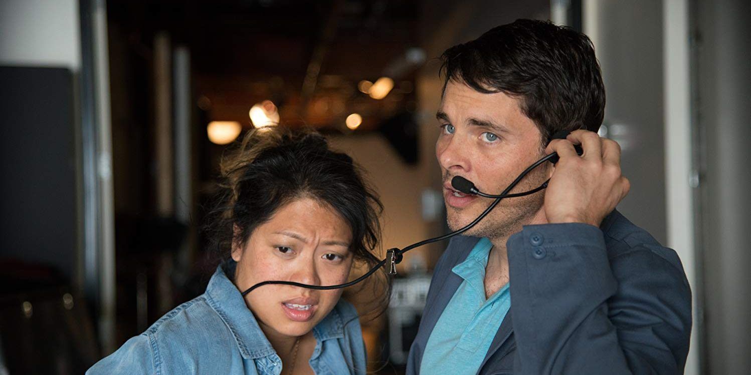Rich and a woman talking through a mic in Welcome To Me.