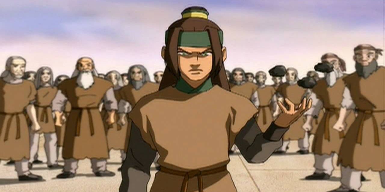 Haru from Avatar: The Last Airbender stands in front of a crowd in a prison.