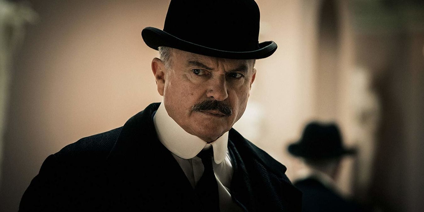 Chester Campbell looks on while wearing a bowler hat in Peaky Blinders.