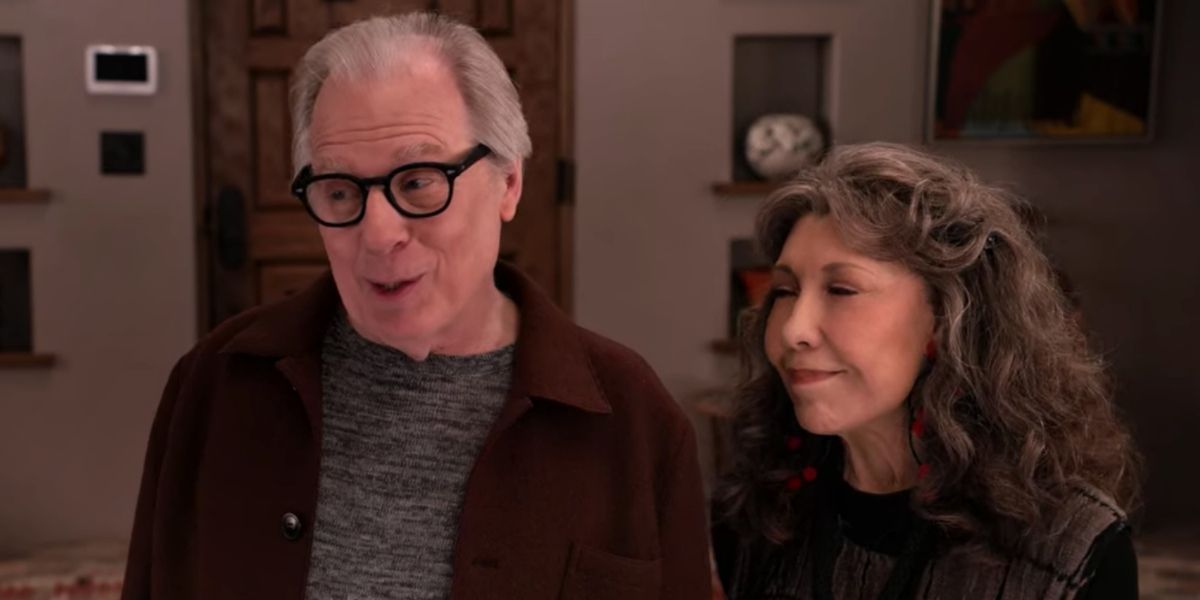 Jack and Frankie standing together smiling in a scene from Grace and Frankie.