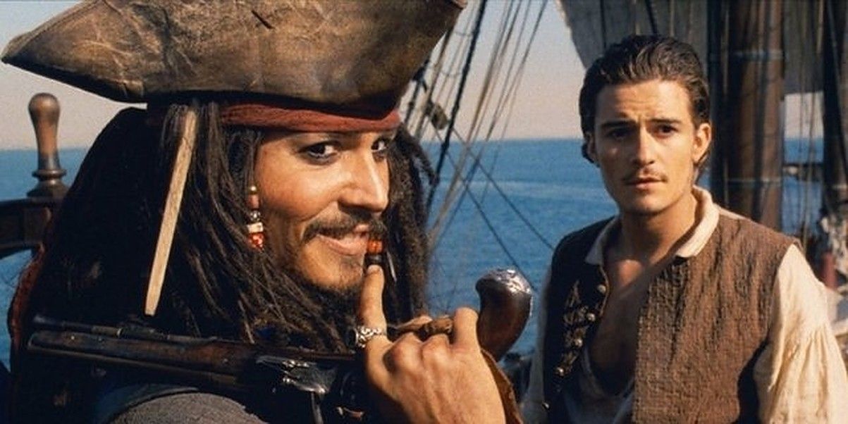 Jack Sparrow smiles over his shoulder as Will Turner looks on