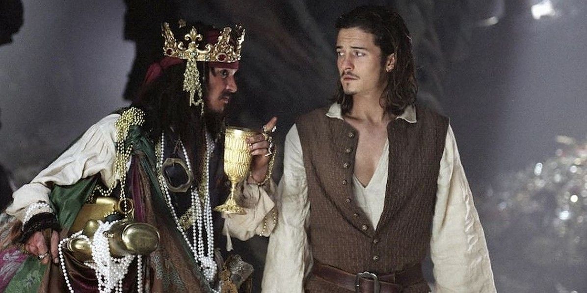 Jack Sparrow covered in trinkets talking to Will Turner