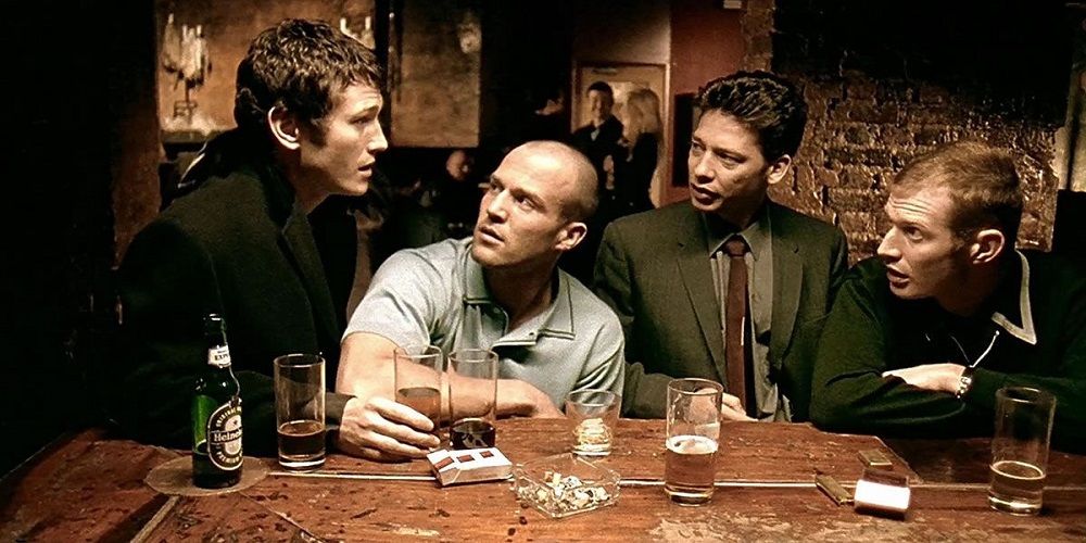 The four protagonists of Lock, Stock and Two Smoking Barrels sitting at a table